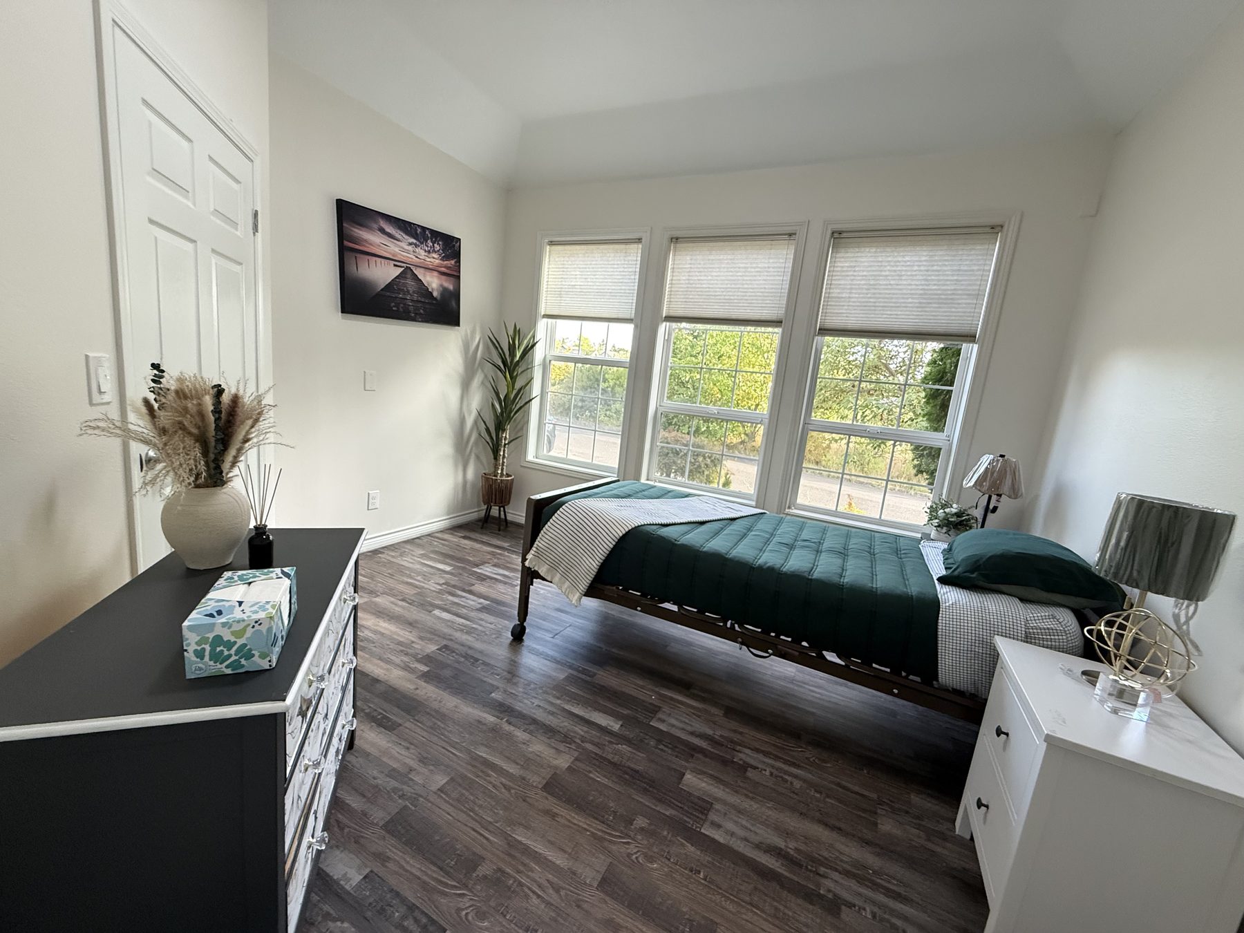 A resident bedroom with large windows